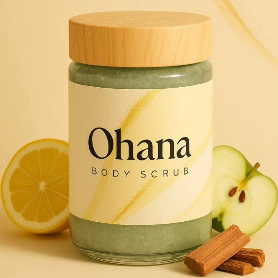 Jar of Ohana body scrub with a wooden lid, lemon, apple, and cinnamon stick on a beige background.