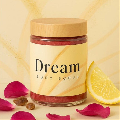 Jar of 'Dream' body scrub with a wooden lid on a yellow background with lemon and rose petals.