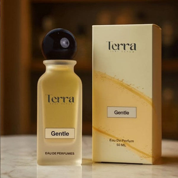 Terra Gentle Eau De Parfum bottle and packaging on a marble surface with a blurred background.
